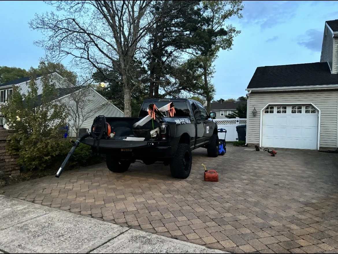 Cutter Bandits truck on-site, blower and gas can staged for the cleanup